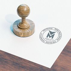 a rubber stamp with the letter m is placed on top of a piece of paper