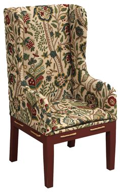 an upholstered chair with a floral pattern on it