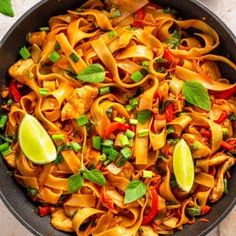 a skillet filled with pasta and vegetables