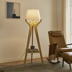 a living room with a chair and lamp in it