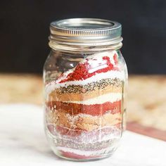 a glass jar filled with red, white and blue cake