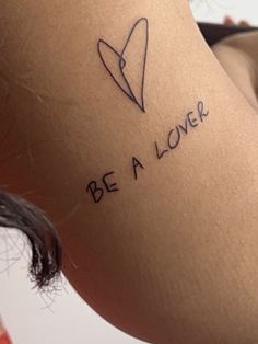 a woman with a tattoo on her leg that says be a lover