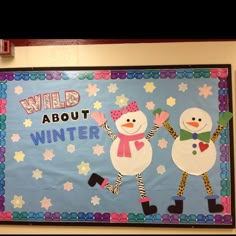 a bulletin board with two snowmen and the words wild about winter written on it