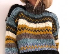 a woman wearing a multicolored knit sweater