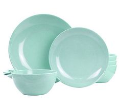 a set of green dishes on a white background