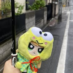 a person holding an umbrella with a stuffed animal on it