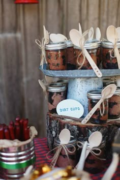 mason jars with spoons are stacked on top of each other and labeled dirt cups