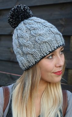 a woman with blonde hair wearing a knitted hat