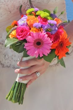 a woman holding a bouquet of flowers in her hand on the instagram page,