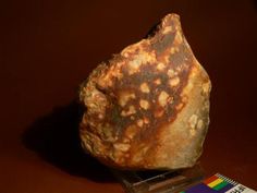 a rock sitting on top of a wooden stand