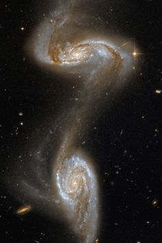 two spiral galaxy like objects in the sky