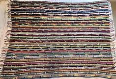 a multicolored rug with fringes on it