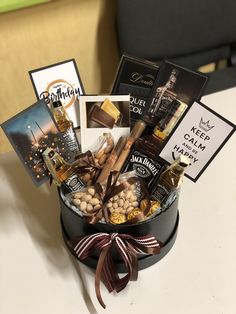 a gift box filled with wine, nuts and greeting cards for someone's birthday