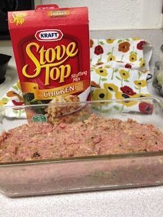 a glass casserole dish filled with ground beef next to a carton of stove top chicken