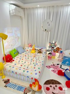 a bed room with a neatly made bed and lots of stuffed animals on the floor