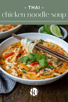 chicken noodle soup in a white bowl with chopsticks and cilantro