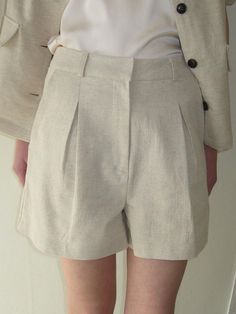 Cut from rayon and linen blend fabric, these shorts have simple yet sophisticated design and are accentuated with pleated tucks through front.  - Natural, relaxed silhouette- A-line design in short length- Classic hook and eye closure- Casual belt loop details- Lined for added flexibility Beige Linen Shorts For Work, Elegant Short Linen Bottoms, Elegant Short Bottoms With Box Pleat, Chic Linen Shorts With Short Inseam, Linen Knee-length Shorts For Work, Elegant High-waisted Linen Shorts, Chic Linen Bottoms With Short Inseam, Beige Pleated Short Bottoms, Pleated Wide Leg Shorts For Work