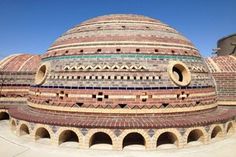 a large brick structure with several circular windows