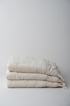 three white towels stacked on top of each other