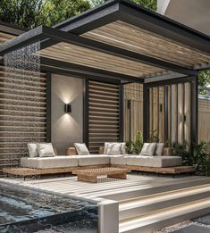 an outdoor living area with couches and water feature