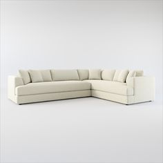 a white sectional couch sitting on top of a white floor