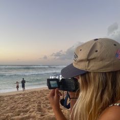 a woman with a camera on the beach