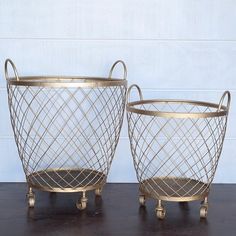 two metal baskets sitting on top of a wooden table