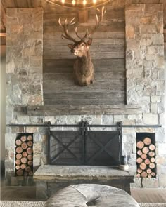 a deer head mounted to the side of a stone fireplace