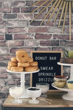 donuts are stacked on top of each other in front of a sign that says donut bar