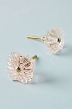 the small flower earrings are clear and gold