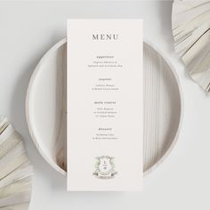 a white plate with a menu on top of it next to some tassels