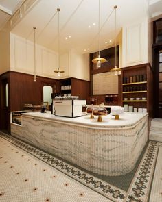 a large kitchen with an island in the middle and lots of counter space around it