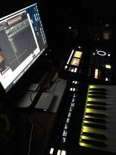 a computer monitor sitting on top of a desk next to keyboard keys and headphones