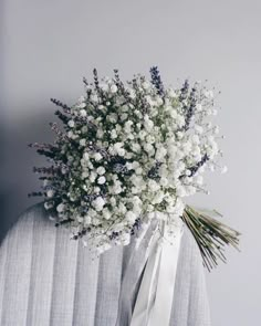 a bouquet of white flowers sitting on top of a chair