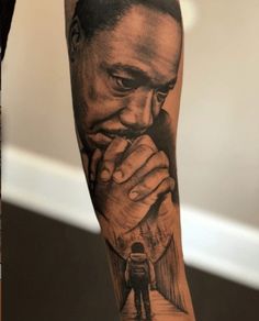 a man's arm with a black and white tattoo of a man holding his hand to his face