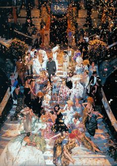 a group of people sitting on top of a boat with confetti in the air