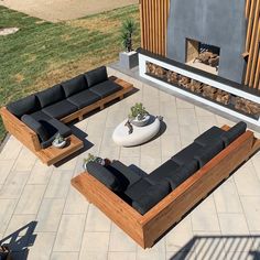 an aerial view of a living room with black couches and coffee table in the center