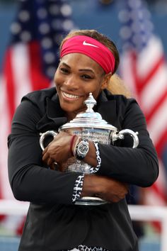 the cover of tennis now magazine with serena williams holding her trophy and wearing a red headband