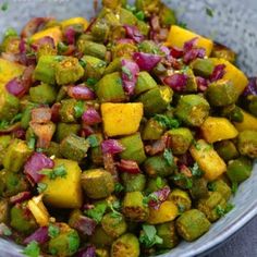 a bowl filled with chopped vegetables on top of a table