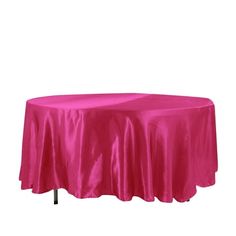 a round table covered with a pink satin tablecloth on an isolated white background for display or montage