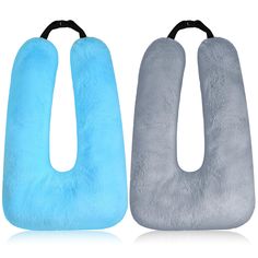 two blue and gray neck pillows sitting next to each other