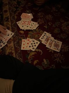 the person is playing cards on the floor