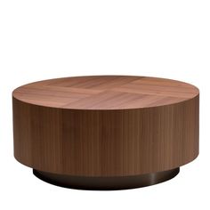 a round wooden table sitting on top of a white floor