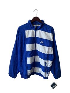 mid 90s adidas windbreaker. lined, lightweight jacket. royal blue & white. side pockets. rubber zipper pull. embroidered mountain logo on chest. in excellent, unworn condition. legit. legitvintage.etsy.com legitvintage on instagram Logo Montagne, 90s Wear, Adidas Originals Jacket, Mountain Logo, 90s Adidas, Mid 90s, Adidas Windbreaker, Adidas Vintage, Retro Logos