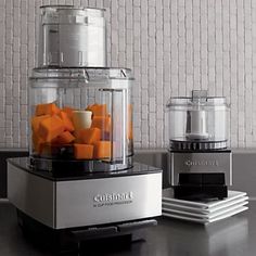 two food processors sitting next to each other on a counter