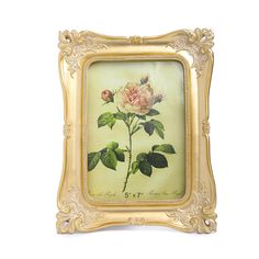 a painting of a pink rose with green leaves in a gold frame on a white background