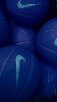 several blue basketballs stacked on top of each other in a basket with the nike logo