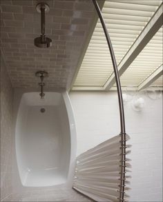 a white bath tub sitting next to a shower head