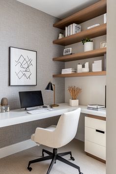 a white desk with a laptop computer on top of it next to a book shelf