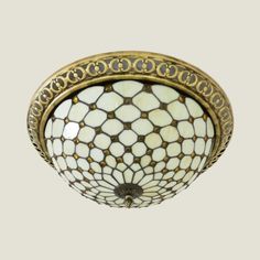 a ceiling light with an intricate design on the top and bottom part of it's lightshade